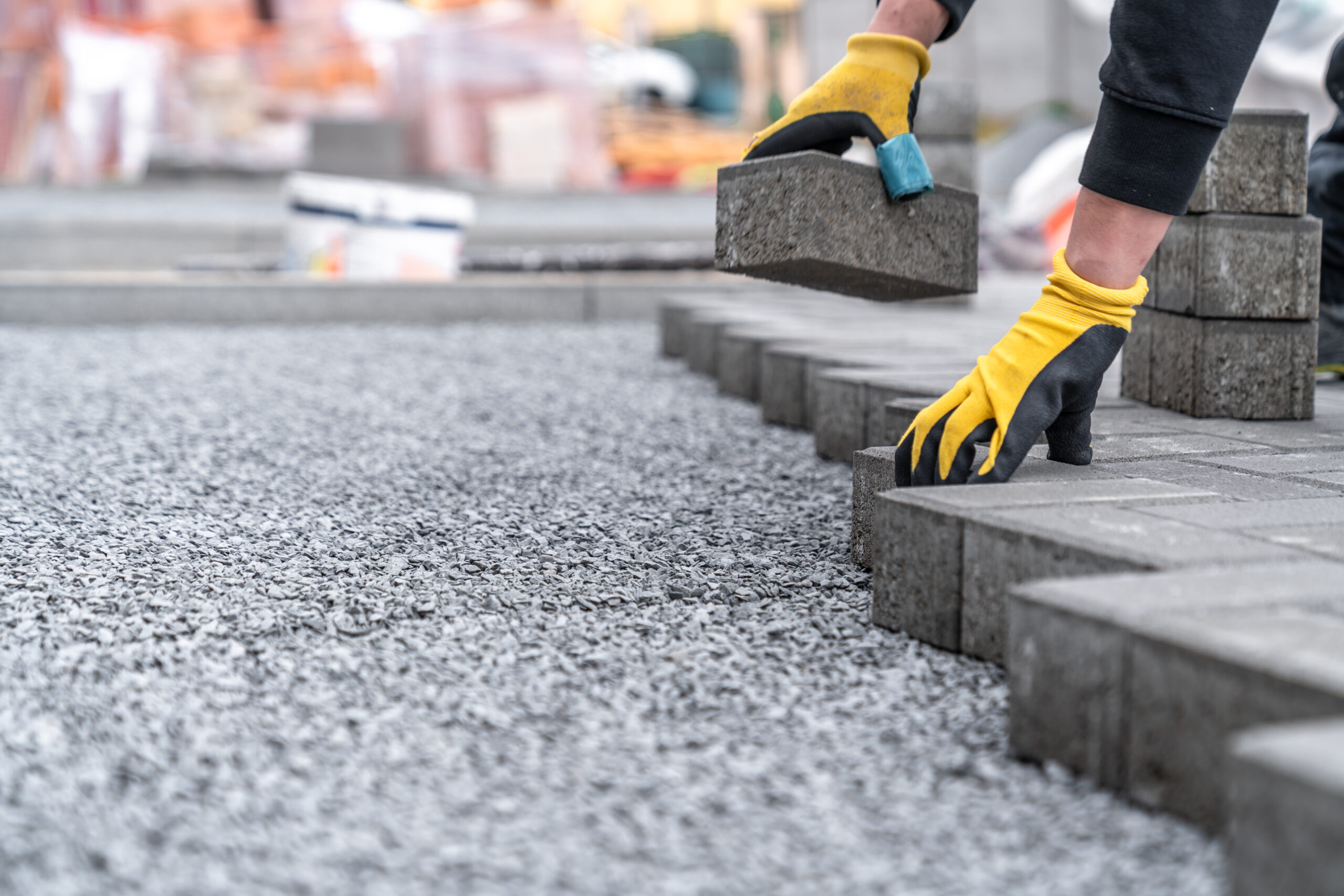 laying interlocking pavers during the construction of sidewalks and roads.